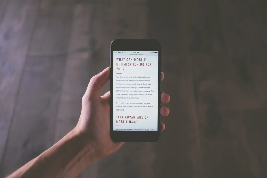 Hand holding a smartphone with a reading page open, ready for mobile manga reading